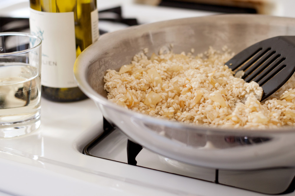 Perfect potluck rice garlic and onions in saucepan on stove