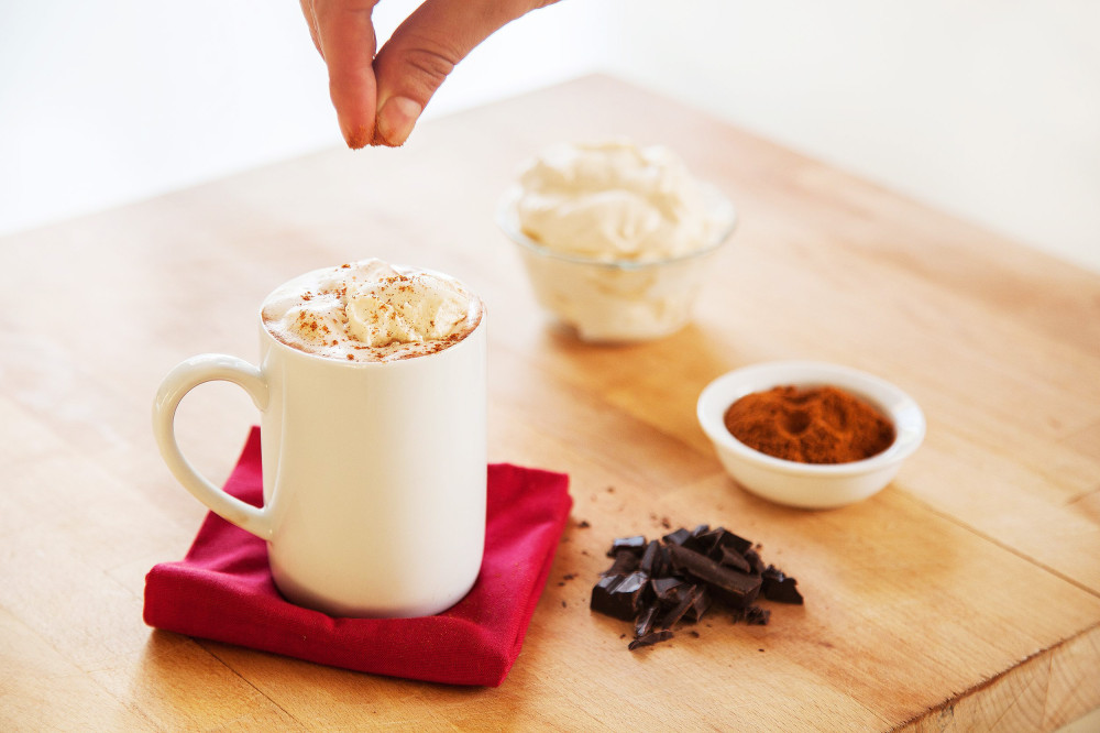 sprinkling chili on hot chocolate