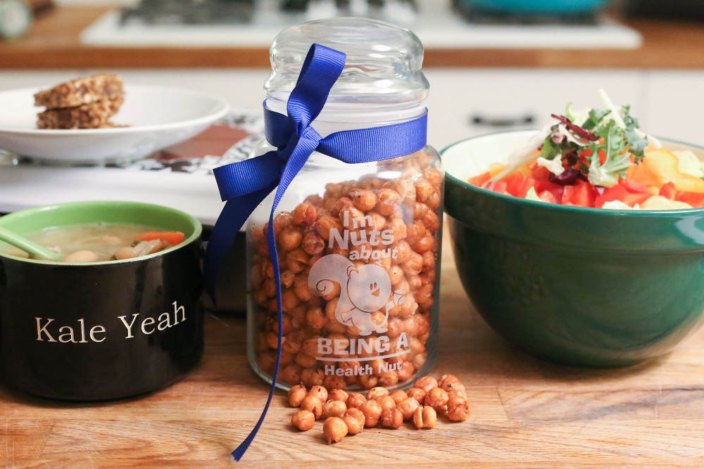 chick peas in a mason jar next to bowls of soup and salad