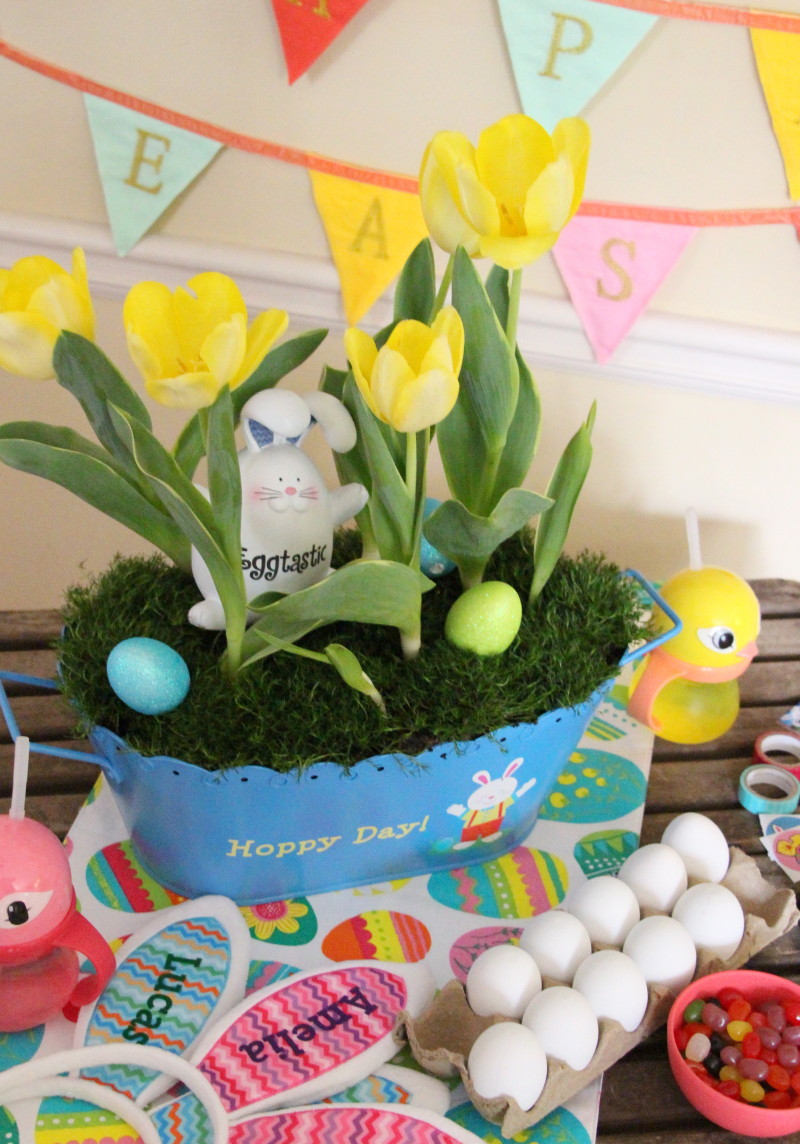 DIY Easter centerpiece with daffodils in blue pot and eggs