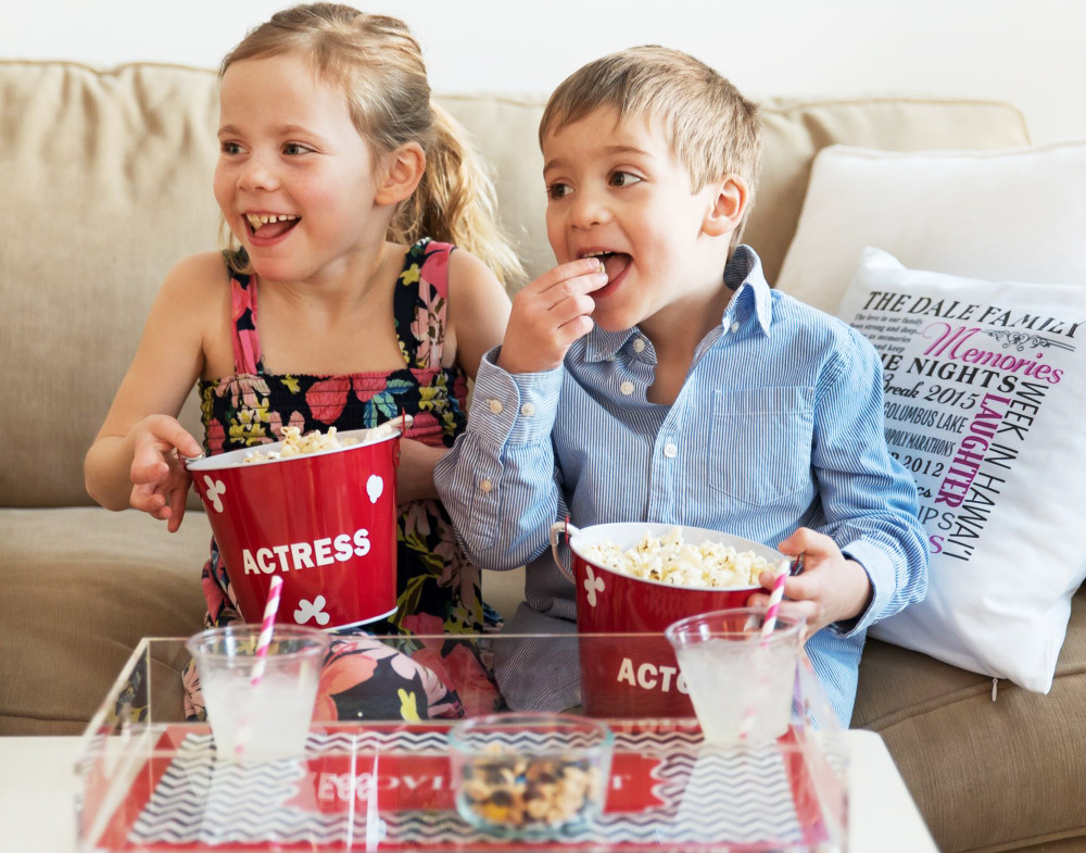 kids eating popcorn from personalized tubs Spring Break on a Budget_6