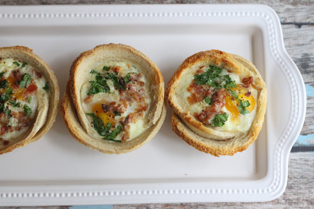 egg toast cups with parsley and bacon on platter
