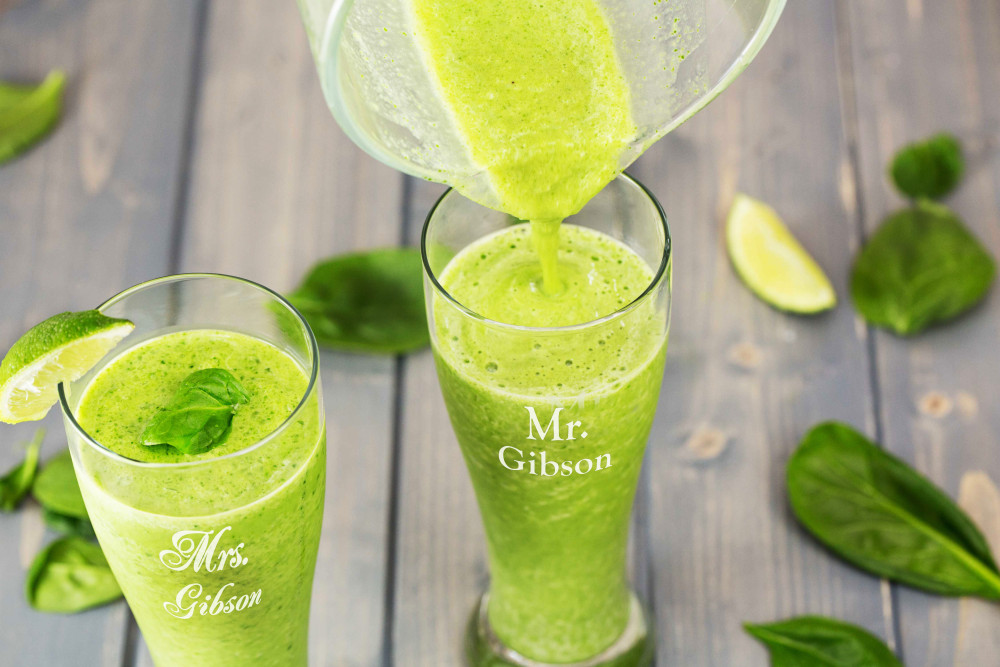 pouring juice smoothies in glasses with lime and mint