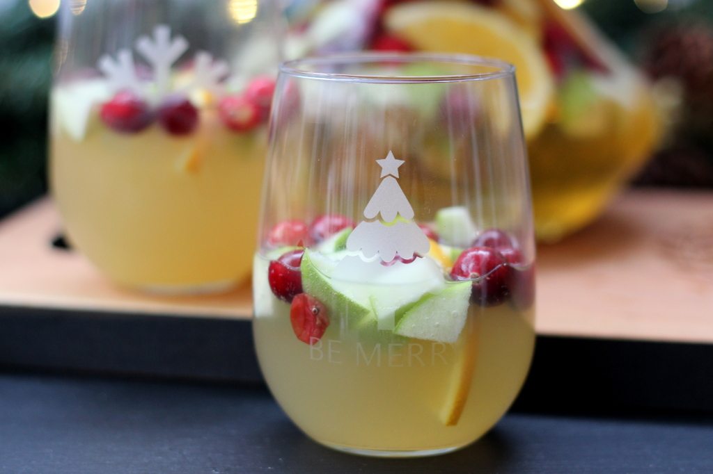 holiday sangria with apples and oranges in personalized glass