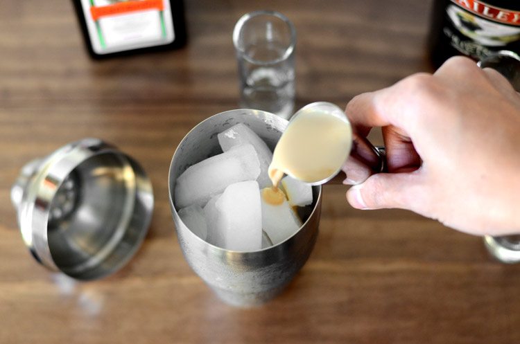 pouring Baileys into the shaker
