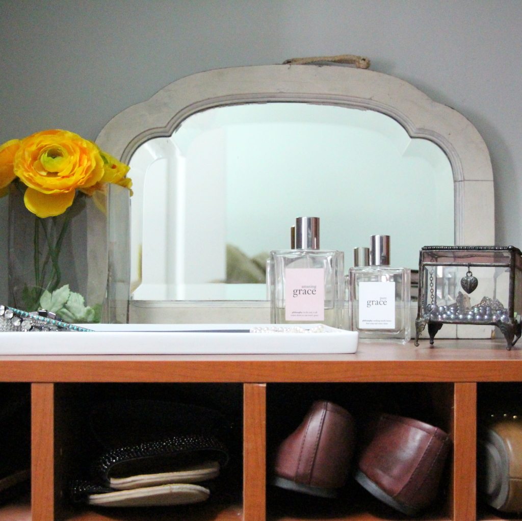 flowers and perfume on shoe case shelf
