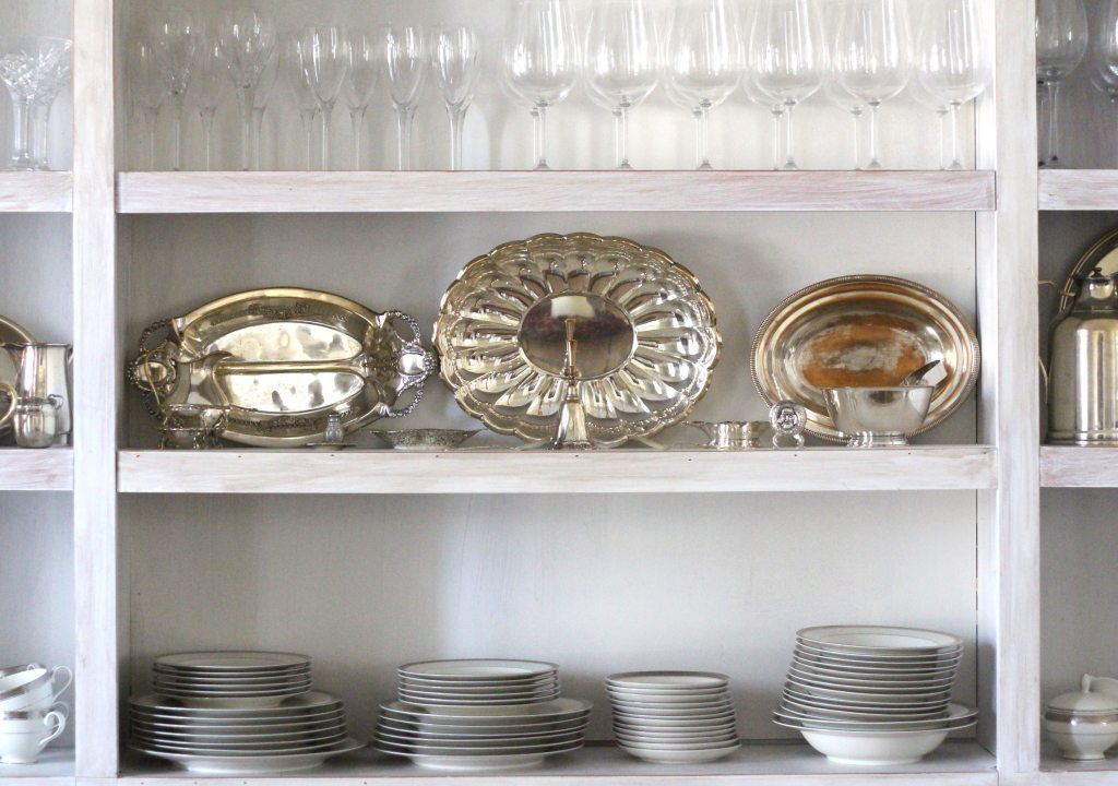 silverware and flatware china dishes and glasses on shelves