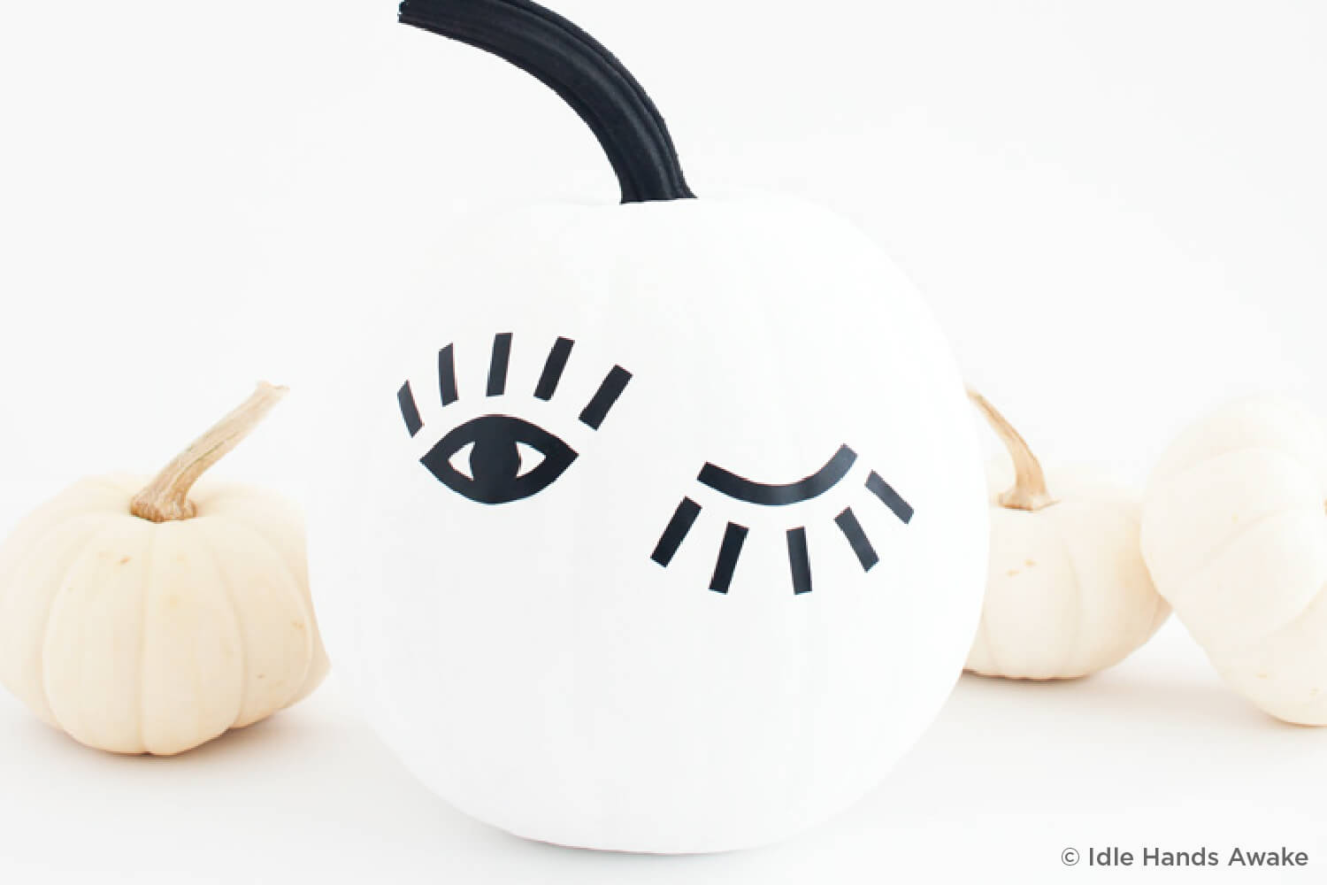 pumpkin painted with eyes that are winking