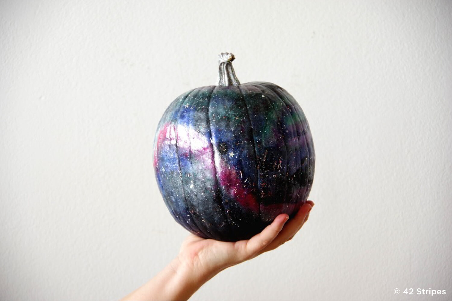 pumpkin painted to look like the galaxy
