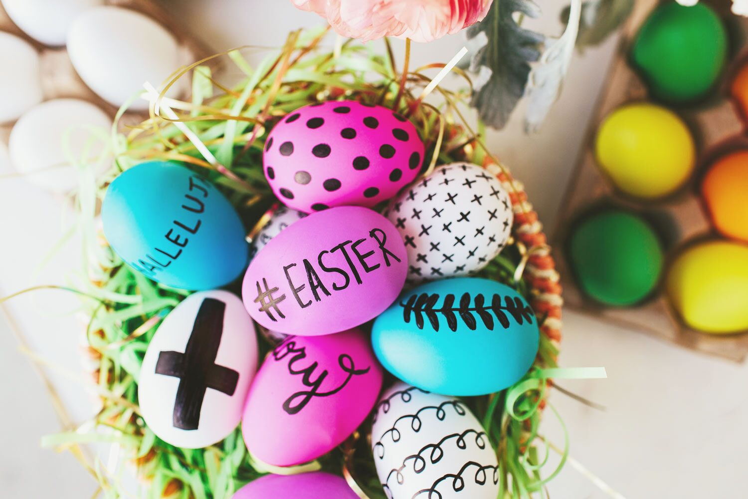 colorful easter eggs with black designs in easter basket