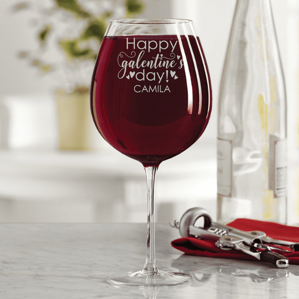 large wine glass with red wine and personalized message