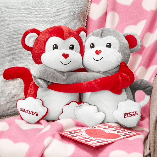 red and grey plush monkeys hugging